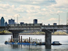Workers move a 50-tonne modular truss into position beneath the Champlain bridge on May 19.