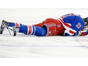 New York Rangers centre Derek Stepan (21) lies on the ice after taking a hit from Canadiens forward Brandon Prust during the first period of Game 3 of the NHL hockey Stanley Cup playoffs Eastern Conference finals in New York. Stepan has a broken jaw and is undergoing surgery.