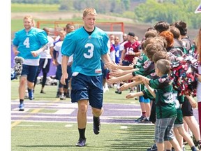 Alouettes quarterback Collin Klein greets kids at the close of the first day of the team’s training camp, at Bishops University in Sherbrooke, east of Montreal, Sunday, June 1, 2014.