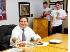 Andrew Molson, vice-chairman of the board of Molson Coors Brewing Corp., shares a sample of a dessert pizza made under the name La Sweetzzeria by students, including Luca Amorosa and John Miceli, at Loyola High School on Thursday, May 29, 2014.