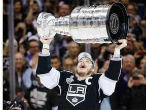 Los Angeles Kings’ Dustin Brown raises the Stanley Cup after beating the New York Rangers in overtime in Game 5 of the Stanley Cup final Friday in Los Angeles.