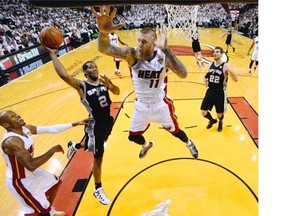 San Antonio Spurs forward Kawhi Leonard (2) goes to the basket as Miami Heat forward Chris Andersen (11) defends in the first half in Game 4 of the NBA basketball finals in Miami on Thursday. The Spurs won 107-86.