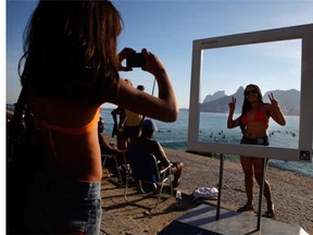 A beachgoer poses for a photo at a suggested Instagram spot on Ipanema Beachon June 8, 2014 in Rio de Janeiro, Brazil. Instagram has more than 200 million users worldwide.