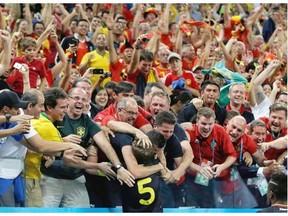 Belgium’s Jan Vertonghen is swarmed by supporters after scoring his side’s first goal during the group H World Cup soccer match between South Korea and Belgium at the Itaquerao Stadium in Sao Paulo, Brazil, Thursday, June 26, 2014.