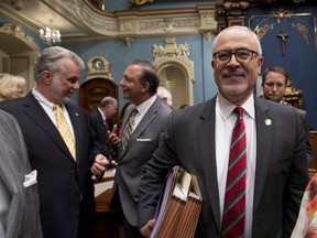 Quebec Finance Minister Carlos Leitao, right, arrives to present the provincial budget Wednesday, June 4, in the National Assembly.