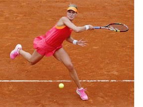 Canada’s Eugenie Bouchard returns the ball to Spain’s Carla Suarez Navarro during their French tennis Open quarter final match at the Roland Garros stadium in Paris on June 3, 2014.