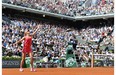 Canada’s Eugenie Bouchard serves to Russia’s Maria Sharapova during their French tennis Open semifinal match at the Roland Garros stadium in Paris on June 5, 2014.