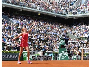 Canada’s Eugenie Bouchard serves to Russia’s Maria Sharapova during their French tennis Open semifinal match at the Roland Garros stadium in Paris on June 5, 2014.