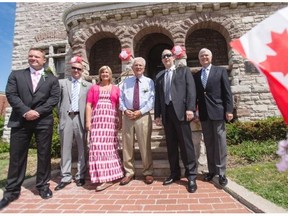 Canadian Baseball Hall of Fame inductees for 2014, from left, the family of scout Jim Ridley, sons Jeremy, Shayne and daughter Shannon, former Montreal Expos General Manager Murray Cook , Expos 3rd baseman Tim Wallach and Expos broadcaster Dave Van Horne, pose for a photo in front of City Hall in St. Mary’s, Ont., Saturday, June 21, 2014.