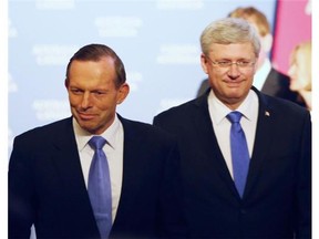 Canadian Prime Minister Stephen Harper (right) and Australian Prime Minister Tony Abbott (left) make their way to a dinner hosted by Harper in Ottawa, Monday June 9 2014.