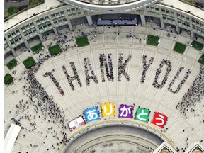 Citizens form “thank you” to celebrate at the Tokyo Municipal Government office square in Tokyo Sunday, Sept. 8, 2013 after the International Olympic Committee chose the city to host the 2020 Olympics. A Westmount hostess isn’t expecting anything this fancy, perhaps just a simple text message.