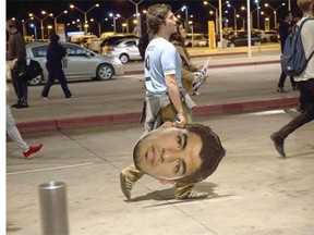 Fans await for the arrival of Uruguay’s striker Luis Suarez outside the Carrasco international airport, 20 km east of Montevideo, on June 26, 2014. Uruguay star Luis Suarez was hit with a global four-month ban for biting an opponent on Thursday as World Cup chiefs imposed the heaviest sanction against a player in the tournament’s history.