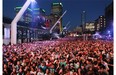 Fans wait for the beginning of the show from French musician, singer and songwriter Woodkid at the opening big free outdoor show at the Montreal International Jazz Festival in Montreal, Thursday, June 26, 2014.