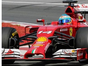 Ferrari F1 driver Fernando Alonso of Spain exits turn three during the Canadian Grand Prix race at the Circuit Gilles Villeneuve in Montreal on Sunday, June 8, 2014.