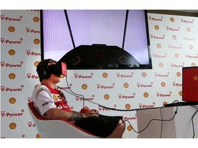 Ferrari Formula One driver Kimi Raikkonen, from Finland, checks out Shell V-Power technology that delivers a virtual reality experience inside an engine on Wednesday in Montreal.