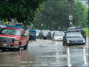 Flash flooding from a severe storm turned streets into rivers and lakes in this view on Lakeshore Rd near Bolan St in Dorval Quebec, Tuesday, June 3, 2014. Photo ©2014 Frederic Hore, RemarkableImages.ca