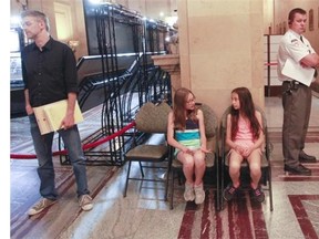 St-Gerard School students Julia Myles (left) and Shanti Proulx at Montreal City Hall Monday, June 16, 2014 in Montreal where they were waiting to ask Mayor Denis Coderre a question at council meeting at Montreal City Hall. Their school has been closed for two years because of mould. Plans to fix the school are being held up by Montreal’s heritage commission. Kids want their own neighbourhood school back, that they don’t have to share with high-schoolers.