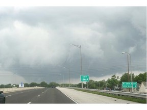 Low-hanging dark crowds are seen in Indianapolis Tuesday. A band of weather across the continent included a low intensity tornado struck near Tottenham, Ont., Tuesday afternoon.