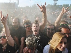 Heavy metal fans gesture during the Hellfest Heavy Music Festival on June 20, 2014 in Clisson, western France.