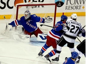 Henrik Lundqvist (30) of the New York Rangers makes a save with Ryan McDonagh (27) of the New York Rangers blocking of Alec Martinez (27) of the Los Angeles Kings from the rebound during the first period of Game Three of the 2014 NHL Stanley Cup Final at Madison Square Garden on June 9, 2014 in New York, New York.