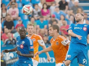 Impact’s Jack McInerney, right, scores against the Houston Dynamo during first half MLS soccer action in Montreal on Sunday.