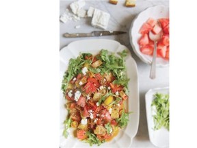 A salad of spring foods contains crisp bread cubes and feta cheese.