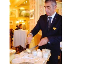 A waiter serves from the cheese board at Paul Bocuse’s Auberge du Pont de Collonges in Lyon.