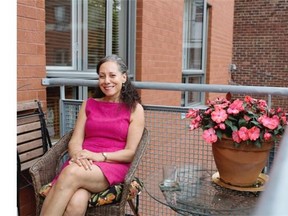 Lina Moros sits on the balcony of her N.D.G. area condo.