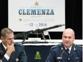 Mario Desmarais, left, with the Montreal Police Department and Michel Arcand with the RCMP speak to reporters during a news conference at RCMP headquarters in Montreal, Thursday, June 12, 2014, where they spoke about Project Clemenza,  a major sweep of two alleged organized crime groups operating in the province.
