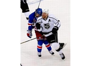 Mats Zuccarello (36) of the New York Rangers and Matt Greene (2) of the Los Angeles Kings collide during the first period of Game Four of the 2014 NHL Stanley Cup Final at Madison Square Garden on June 11, 2014 in New York, New York.