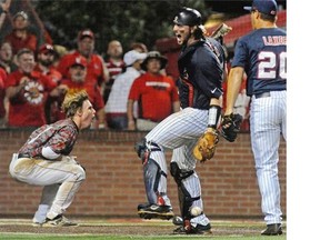 Mississippi’s catcher Will Allen, left, celebrates after tagging Louisiana Lafayette’s Caleb Adams out at home for the third out of the seventh inning during an NCAA college baseball tournament super regional game in Lafayette, La., Monday, June 9, 2014.