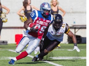 Montreal Alouettes running back Brandon Rutley, left, shakes off the tackle by Hamilton Tiger-Cats linebacker Marc Beswick during pre-season CFL action in Hamilton, Ont., Saturday.