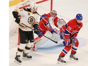 Montreal Canadiens defenceman Andrei Markov, right, blocks a shot in front of goalie Carey price and Boston Bruins Milan Lucic during second period of Game 6 of Stanley Cup playoff series in Montreal Monday May 12, 2014.