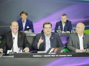 Montreal Mayor Denis Coderre, centre, speaks during a news conference to announce the Canadian Grand Prix’s stay in Montreal for another 10 years along with Quebec Transport Minister Robert Poëti, bottom right, federal Infrastructure Minister Denis Lebel, bottom left, President and CEO of Tourisme Montréal Yves Lalumière, top left, and Canadian Grand Prix organizer François Dumontier, top right, at the Circuit Gilles Villeneuve in Montreal on Saturday, June 7, 2014.