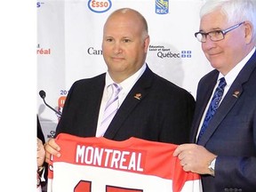 Newly appointed head coach of Canada’s national junior hockey team, Benoit Groulx, left, with Bruce Hamilton of Hockey Canada following announcement in Montreal on Thursday June 12, 2014.