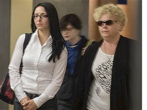 Emma Czornobaj left, leaves the Montreal Court room with a supporter Monday, June 2, 2014. Czornobaj has been charged with criminal negligence and dangerous driving causing two deaths when she stopped her car on a highway to avoid hitting a family of ducks.
