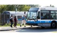 Commuters head to buses after getting off AMT train at Roxboro-Pierrefonds commuter train station in Pierrefonds. Despite spending $5.5 million on studies, the AMT is no closer to a solution to West Island transit woes.