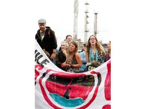 A group of people are marching from Cacouna to Kanesatake to raise awareness about the proposed Energy East pipeline that will carry crude oil from Alberta to a port in Cacouna. They are seen at the Suncor oil refinery in Montreal on Thursday June 5, 2014.