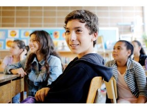 Grade six student Moncef Benlalam listens as his English teacher, Eziz Sansone, not seen, speaks to the class at École Beau-Séjour in the Saint-Laurent district of Montreal on Tuesday June 10, 2014.