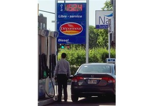 Montrealer fills up at 152.4 cents a litre at gas station on corner of Papineau and St-Zotique on Thursday June 19, 2014.