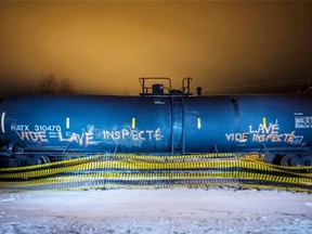 A night photo of an empty train wagon that carried crude oil sitting near the site of the train explosion in Lac-Mégantic.