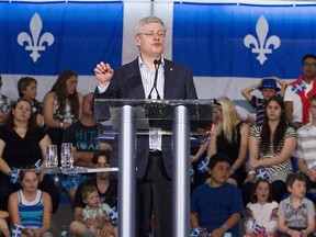 Prime Minister Stephen Harper speaks at a holiday gathering in Saint-Lazare-de-Bellechasse, Que.,  on Tuesday.
