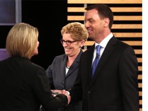 Ontario NDP Leader Andrea Horwath, left, Premier Kathleen Wynne and Ontario Progressive Conservative Leader Tim Hudak speak after taking part in the provincial leaders’ debate in Toronto on June 3, 2014.