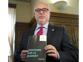 Quebec Finance Minister Carlos Leitão holds a copy of his speech on the eve of his budget presentation, Tuesday, June 3, 2014. Leitão said in the speech that he only announced tax increases “with which most Quebecers likely agree.”