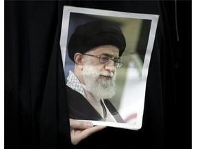 An Iranian hardline student holds a portrait of Iran's supreme leader, Ayatollah Ali Khamenei, during a gathering outside the former U.S. embassy in Tehran in 2011. Khamenei has been an opponent of the Baha'i minority in Iran.