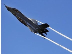 An F-35 Lightning II Joint Strike Fighter test aircraft banks over the flightline at Eglin Air Force Base, Fla., April 23, sending contrails streaming off the wings.