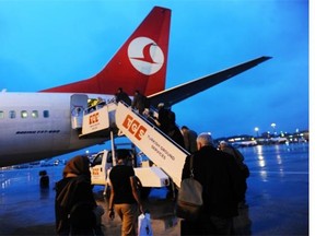 Passengers get into a Turkish Airlines aircraft on March 16, 2013, at the Ataturk Airport in Istanbul.