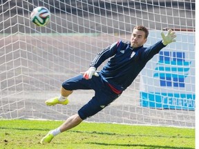 Russian national soccer team goalkeeper Igor Akinfeev reaches for a ball during a training session in Moscow, Russia, Wednesday, June 4, 2014. Russia will face Morocco on Friday, June 6, 2014, in the last friendly match before leaving for Brazil to compete in the World Cup.