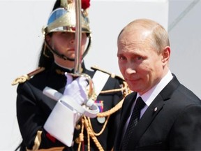 Russian President Vladimir Putin, right, arrives at a ceremony of the commemoration of the 70th anniversary of the D-Day in Ouistreham, western France, Friday, June 6, 2014.