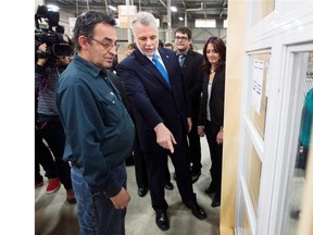 Small and medium-size businesses in the manufacturing sector were the big winners in the Wednesday budget. Quebec Liberal leader Philippe Couillard, centre, speaks to an employee while campaigning at a window manufacturing plant March 28, 2014, in Blainville.